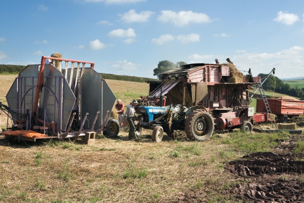 The team leader is seen in front of the tractor